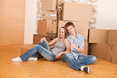 Removalists carrying items through a central London apartment building