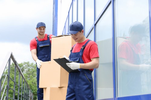 Moving team handling boxes and furniture in a Marylebone apartment building